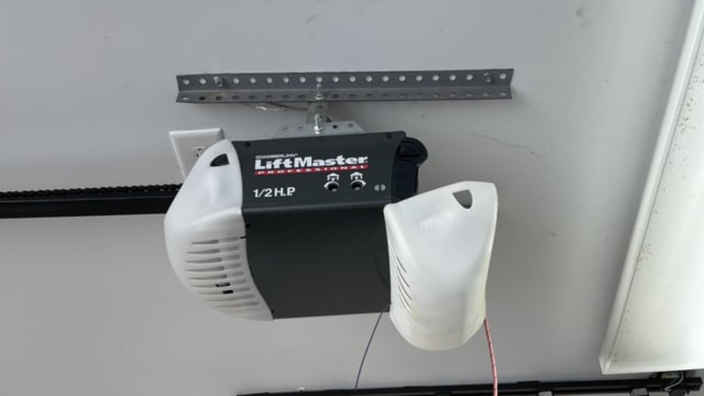 A garage door opener being repaired by Isabella Garage Door